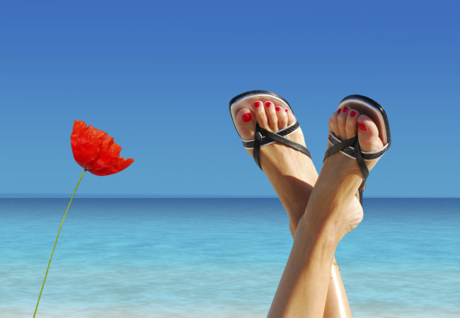 feet crossed on an island paradise