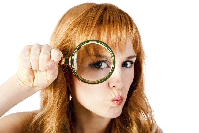 woman with magnifying glass isolated on a white background