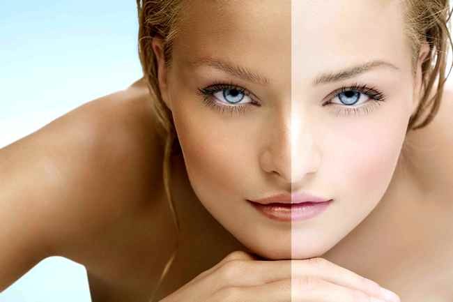 Beauty visual about suntan. Model's face divided in two parts - tanned and blanc.