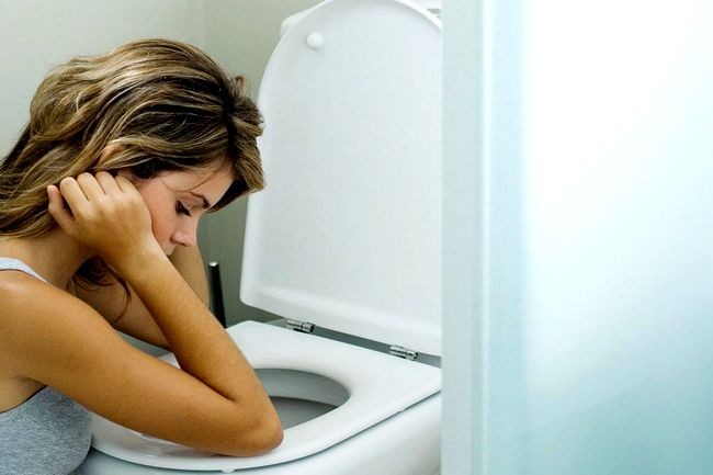 Young-woman-sitting-next-to-toilet